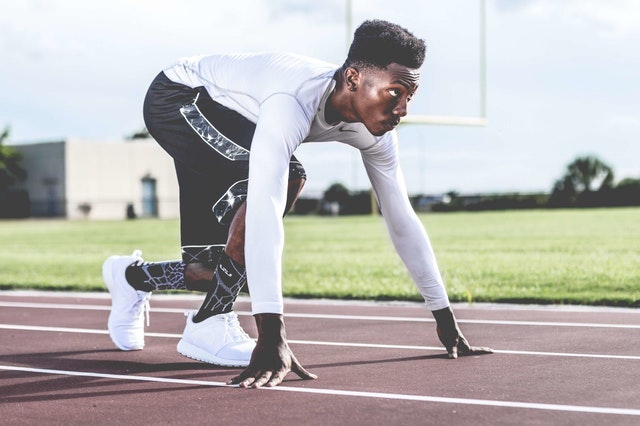 A runner on a track preparing to run